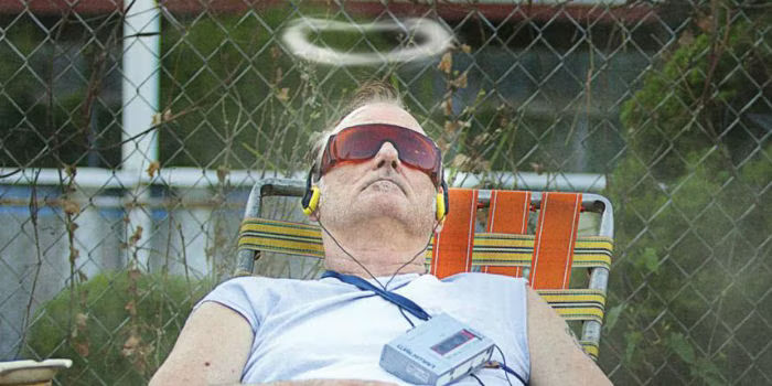Bill Murray lying in a lawn chair with a smoke halo over his head in St. Vincent 