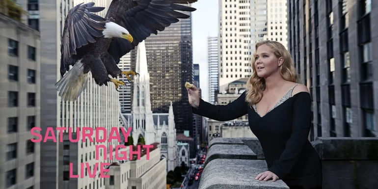 Amy Schumer reaching out to an eagle on a Saturday Night Live poster