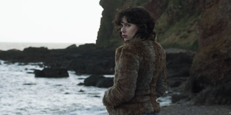 The woman stands by the sea in Under the Skin