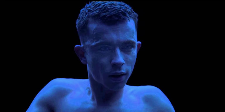 A man stares in a dark abyss in Under the Skin