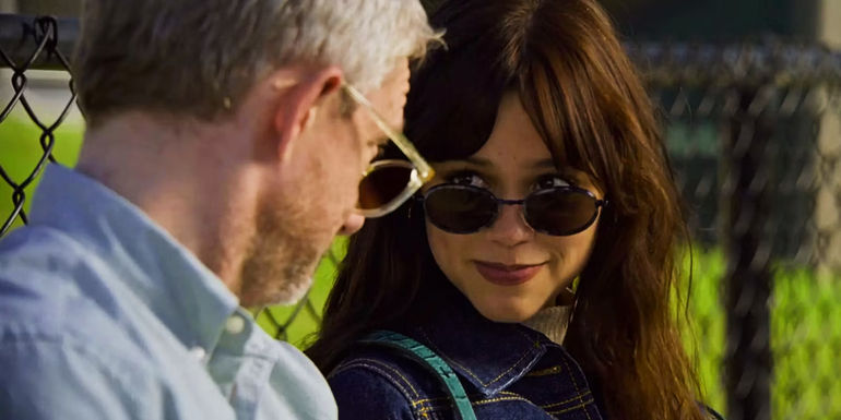 Mr. Miller and Cairo look over their sunglasses at each other while smiling in Miller's Girl