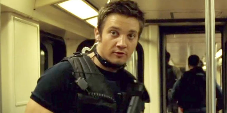 Brian (Jeremy Renner) with a gun on a train in S.W.A.T.