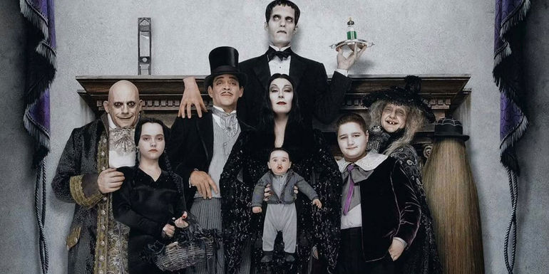 Addams Family Values cast members pose for a family portrait in a promotional image for the movie