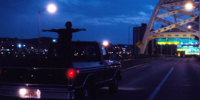 Charlie standing up in a truck in the perks of being a wallflower final scene