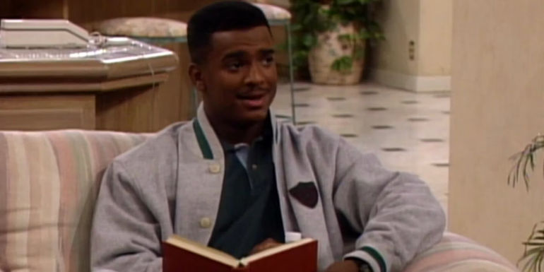 Carlton Banks sitting down with a book in hand