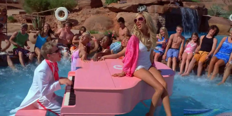 Sharpay (Ashley Tisdale) sitting on a piano that Ryan (Lucas Grabeel) is playing in a pool in in High School Musical 2 