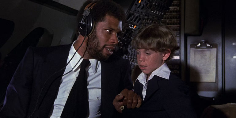 Kareem Abdul-Jabbar talks to a kid while as a pilot in Airplane