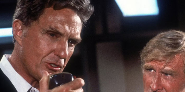 Robert Stack as Rex Kramer speaking into a radio in Airplane