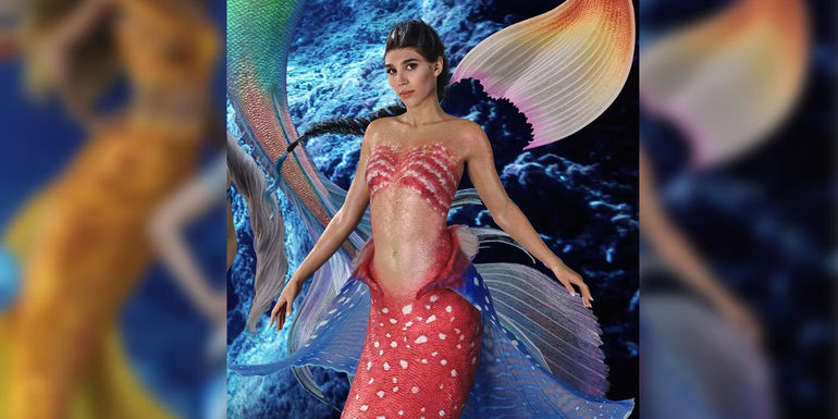 Lorena Andrea as Perla with red and white scales and fins in the live action The Little Mermaid