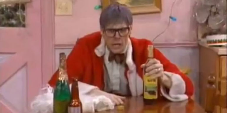 Grandpa Jack McGee (Jim Carrey) in a santa outfit surrounded by alcohol in In Living Color.