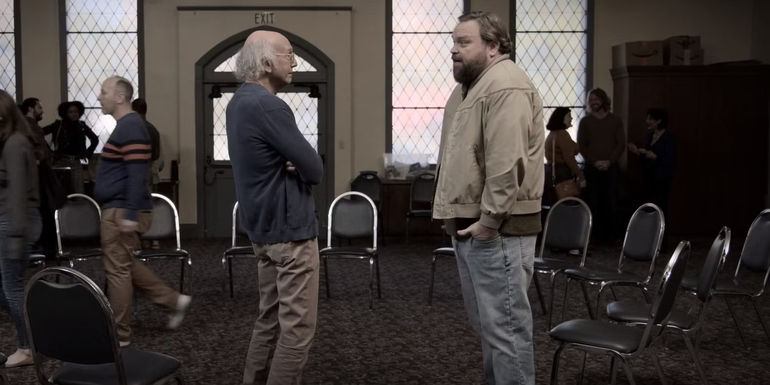 Larry talks to Irma's sponsor in Curb Your Enthusiasm