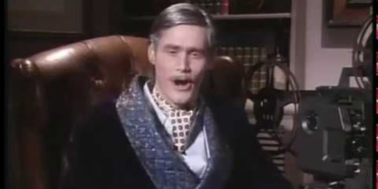 Ted Turner (Jim Carrey) sitting in a robe in In Living Color.