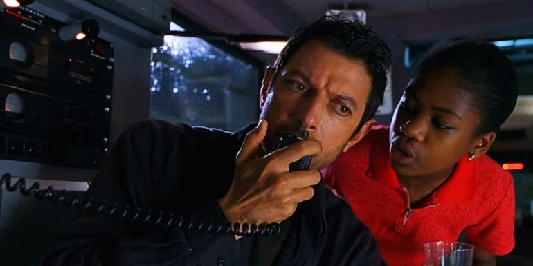 Kelly Malcolm looks over at Ian Malcolm as he talks on the radio in The Lost World.
