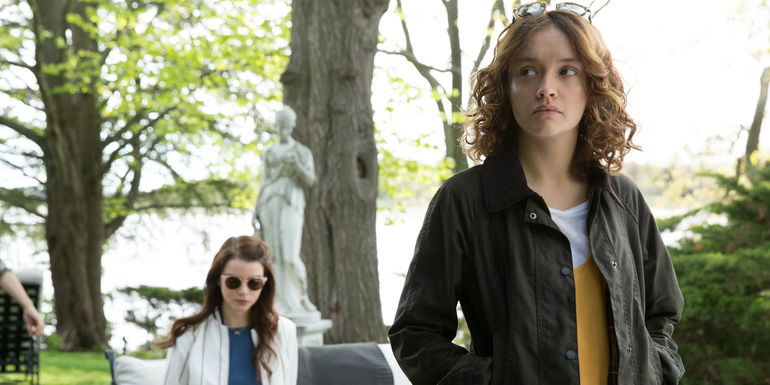 Amanda looking to her right while Lily sits in the background in Thoroughbreds.