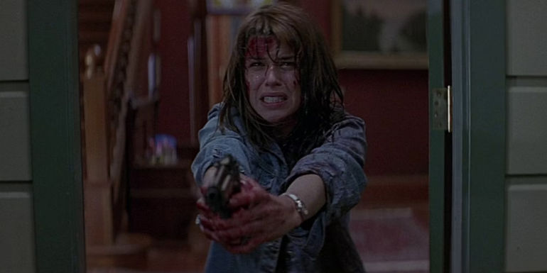 Neve Campbell's Sidney Prescott holds a gun in Scream