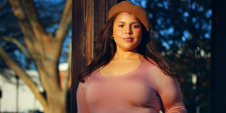 Winter Everett from The Family Chantel wearing brown top and beret smiling