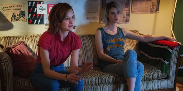 Cameron and Donna sitting on a couch in an apartment in Halt and Catch Fire