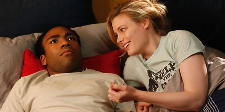 Donald Glover staring at the ceiling as Troy Barnes in Community as Gillian Jacobs' Britta Perry talks to him