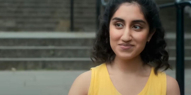 Emma stands on the stairs in One Day