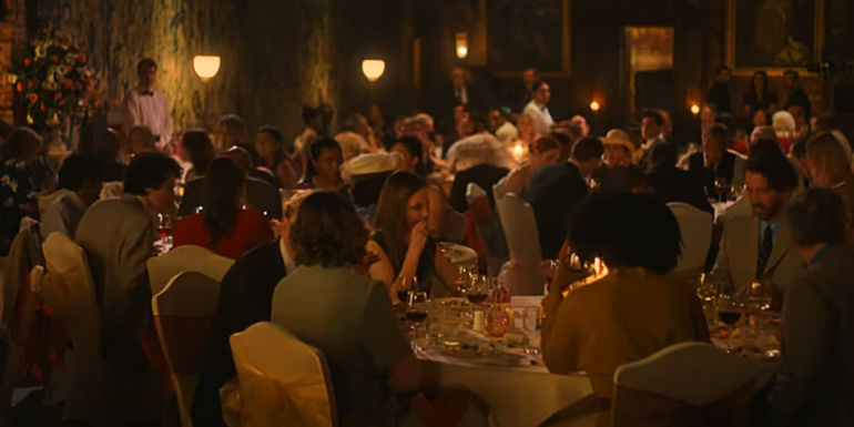 Guests at Tilly's wedding sit at their tables in One Day