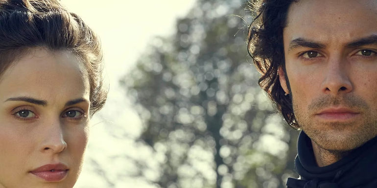 Elizabeth and Ross looking at the camera in Poldark