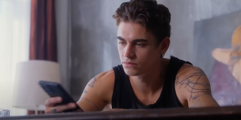 Hardin looks at his phone in After Everything 