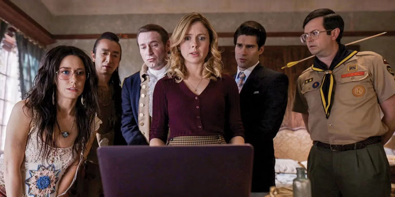 The ghosts look at a computer in Ghosts season 2.