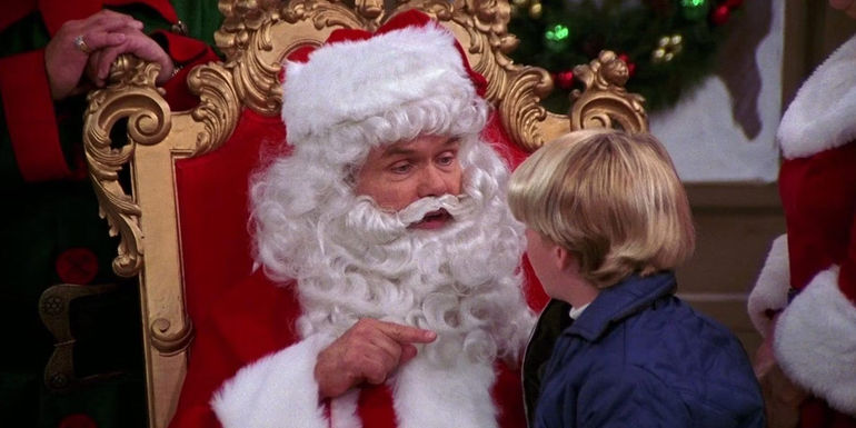 Red (Kurtwood Smith) points his finger at a child sitting on his lap while dressed as Santa Claus in That '70s Show season 6, 