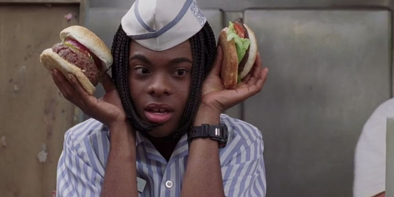 Ed (Kel Mitchell) holding two burgers against his ears in Good Burger