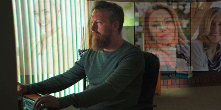 A man sitting at a computer in Lover, Stalker, Killer