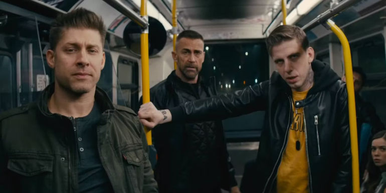 A trio of men on a subway in Nobody