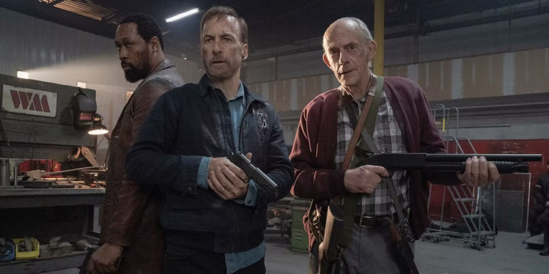 RZA, Bob Odenkirk, and Christopher Lloyd holding guns in a warehouse in Nobody
