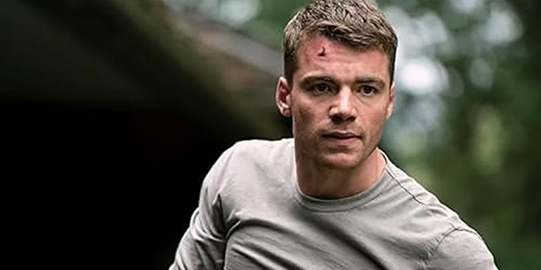 Gabriel Basso starring at something in The Night Agent.