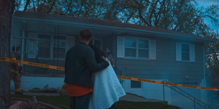 Dave and Liz standing outside of her burning home. 