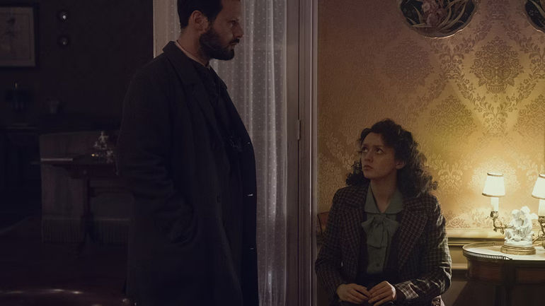 Maisie Williams sits and Hugo Becker stands in The New Look