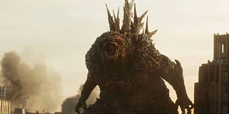 Godzilla roaring in Godzilla Minus One with city destruction behind him