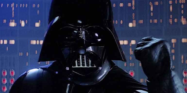 Darth Vader raises his fist and tries to convince Luke to join him in The Empire Strikes Back