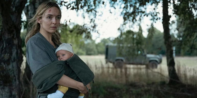 Jodie Comer looks exhausted while holding a baby in The End We Start From