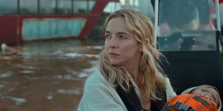 Jodie Comer looks wistful while cradling a baby in The End We Start From