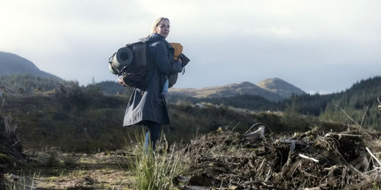 Jodie Comer summits a hill with camping gear and a baby in The End We Start From