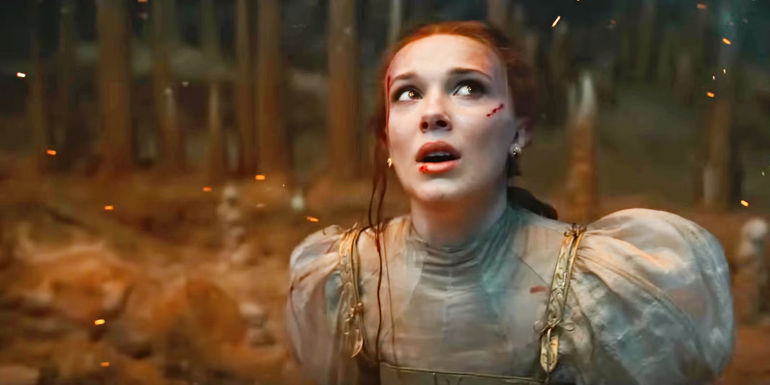 Millie Bobby Brown as Princess Elodie looking up with astonishment in Damsel