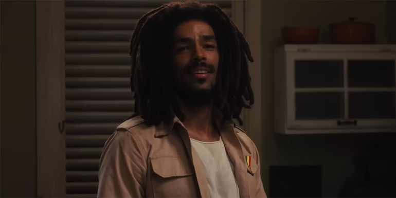 Kingsley Ben-Adir as Bob Marley smiling in Bob Marley: One Love