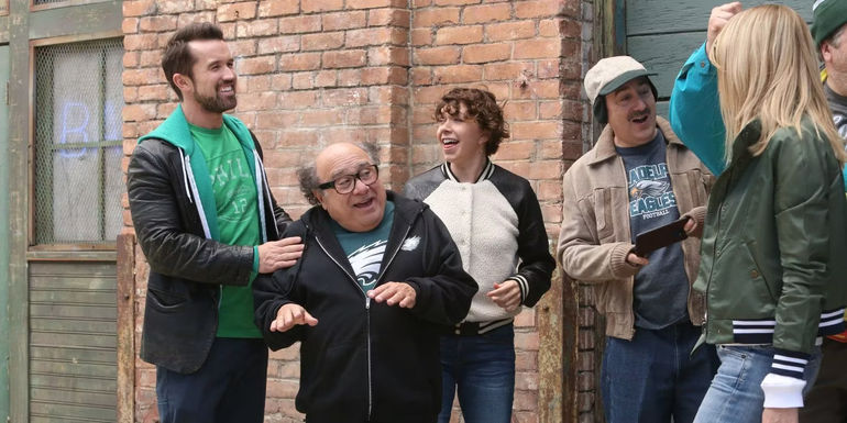 Mac (Rob McElhenney), Frank (Danny DeVito), and other characters from IASIP getting ready to go to the Super Bowl.