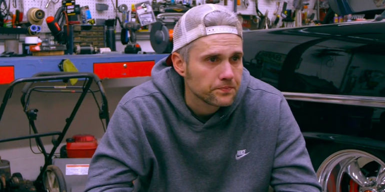 Ryan Edwards from Teen Mom crying in a car garage.