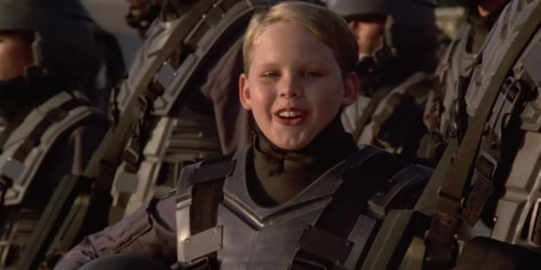 A young child in armor in a military PSA in Starship Troopers
