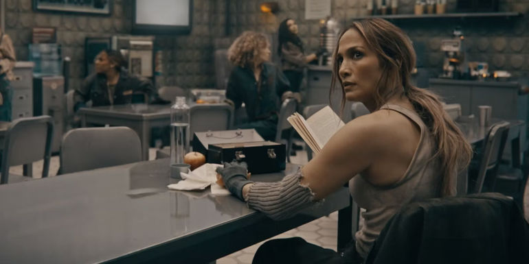Jennifer Lopez Sitting At Table With A Book In This Is Me...Now: A Love Story.jpg