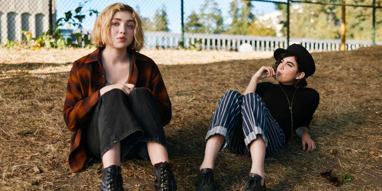 Maddie and Rhonda sitting in the grass conversing in School Spirits