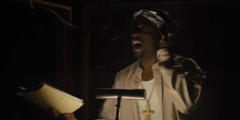 Tupac (Marcc Rose) singing in a recording booth in Straight Outta Compton.