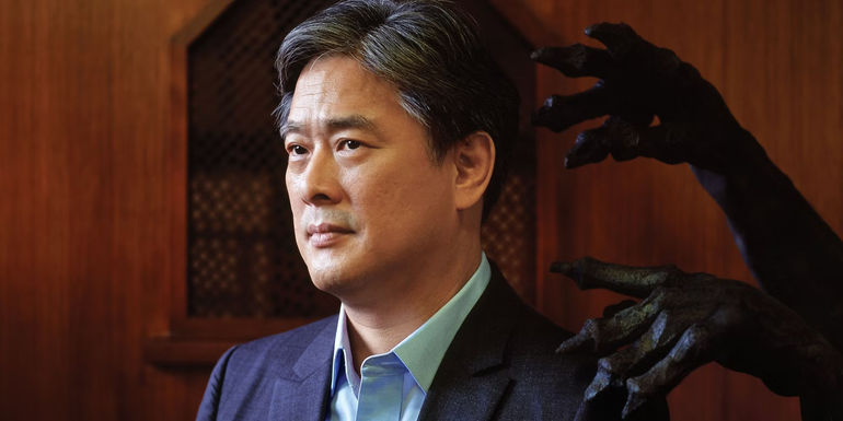 Director Park Chan-wook standing in front of a statue