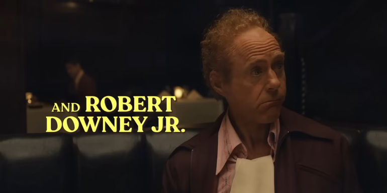 Robert Downey Jr. in a disguise with his name written on screen in The Sympathizer trailer